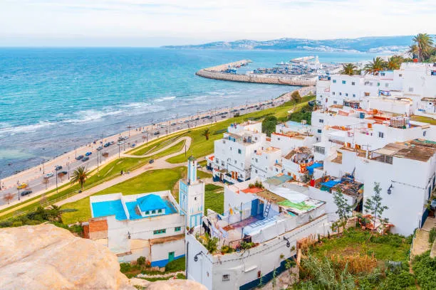 Panoramic view of Tangier city in northern Morocco with the historic medina, coastal skyline, and the meeting point of the Mediterranean Sea and Atlantic Ocean.